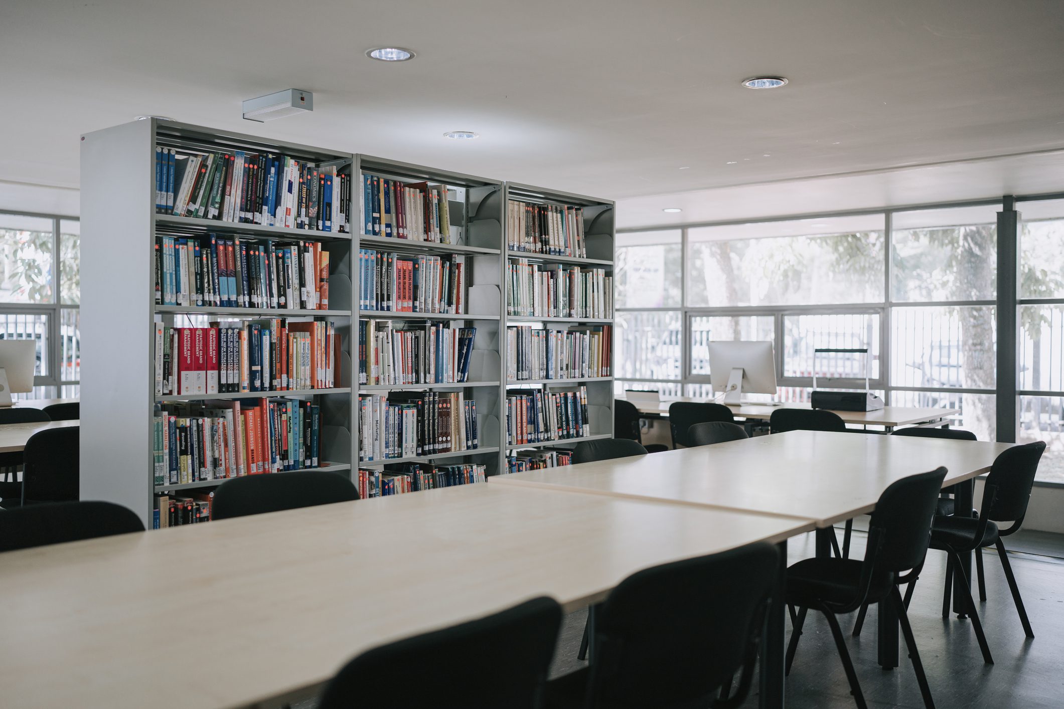 Empty library with bookshelves and tables