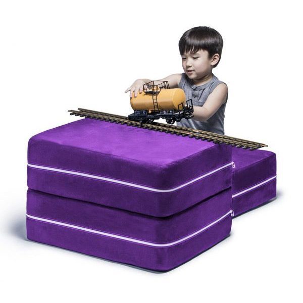 Kid balancing train on purple blocks
